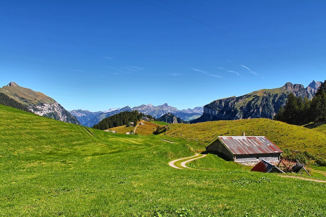 Traditional Swiss wooden chalet in the alps surrounded by mountains